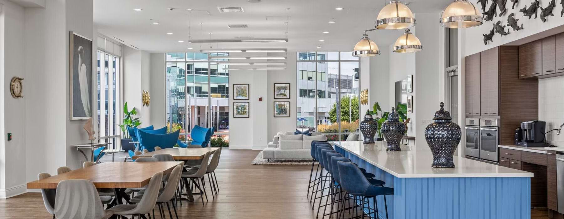 a clubroom kitchen with a bar, tables and chairs